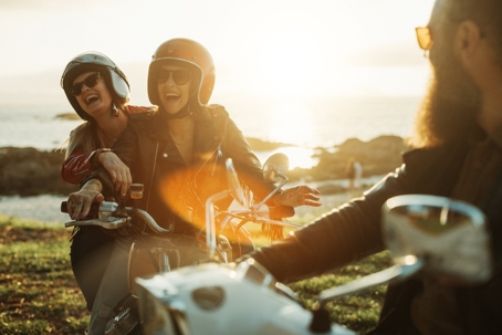group of friends on motorcycles enjoying the sunset
