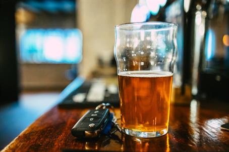 beer and car keys on a bar
