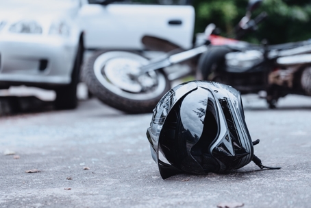 helmet on the road in front of motorcycle crash scene